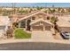 Aerial view of a two-story home with a three-car garage, manicured lawn, and desert landscaping at 15055 S 40Th Pl, Phoenix, AZ 85044