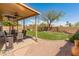 Spacious backyard featuring a grassy lawn, patio, mature trees, and privacy fence at 15055 S 40Th Pl, Phoenix, AZ 85044