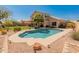 Beautiful backyard featuring a pool, desert landscaping, and a covered patio at 15055 S 40Th Pl, Phoenix, AZ 85044
