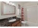 Standard bathroom with tile floors, tub shower combination and dark wood vanity at 15055 S 40Th Pl, Phoenix, AZ 85044