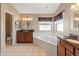 This primary bathroom features a garden tub, granite counters, and dual sinks at 15055 S 40Th Pl, Phoenix, AZ 85044