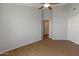 This bedroom offers wood floors, neutral walls, a ceiling fan, and an en suite bathroom at 15055 S 40Th Pl, Phoenix, AZ 85044