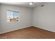 This bedroom offers wood floors, neutral walls, and a large window with outdoor views at 15055 S 40Th Pl, Phoenix, AZ 85044