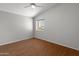Minimalist bedroom with vaulted ceilings, wood floors, a ceiling fan and a window overlooking the neighborhood at 15055 S 40Th Pl, Phoenix, AZ 85044
