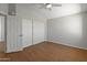 Clean, modern bedroom with wood floors, a ceiling fan and closet featuring sliding doors at 15055 S 40Th Pl, Phoenix, AZ 85044