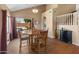 Dining area featuring a round wooden table, natural light, and backyard view at 15055 S 40Th Pl, Phoenix, AZ 85044