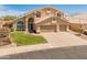 Two-story home with manicured front yard, arched windows and three car garage at 15055 S 40Th Pl, Phoenix, AZ 85044