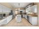 Spacious kitchen with white cabinetry, stainless steel appliances, and a central island at 15055 S 40Th Pl, Phoenix, AZ 85044