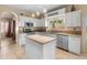 Bright kitchen with white cabinets, granite countertops, stainless steel appliances and a central island at 15055 S 40Th Pl, Phoenix, AZ 85044