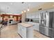 Bright, open kitchen with granite countertops, white cabinets, and stainless steel appliances overlooking the living room at 15055 S 40Th Pl, Phoenix, AZ 85044