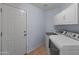 Well-lit laundry room with modern appliances and tiled floor at 15055 S 40Th Pl, Phoenix, AZ 85044