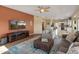 Cozy living room featuring a fireplace, television, and access to kitchen at 15055 S 40Th Pl, Phoenix, AZ 85044