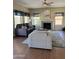 Cozy living room with fireplace, ceiling fan, and large windows, creating a warm and inviting atmosphere at 15055 S 40Th Pl, Phoenix, AZ 85044