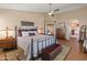 Cozy main bedroom featuring wood floors, ceiling fan and a doorway to the main bath at 15055 S 40Th Pl, Phoenix, AZ 85044