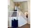 Elegant staircase with white railings, complemented by a stylish black accent table and decorative niche at 15055 S 40Th Pl, Phoenix, AZ 85044