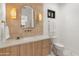 Stylish powder room features a modern vanity, sleek fixtures, decorative mirror, and unique tile work at 1506 E Tuckey Ln, Phoenix, AZ 85014