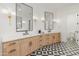 Elegant bathroom featuring dual vanities with stone countertops and unique tile flooring, offering a spa-like ambiance at 1506 E Tuckey Ln, Phoenix, AZ 85014