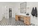 Bright bathroom featuring a vanity with a large mirror, stylish lighting, and a patterned floor at 1506 E Tuckey Ln, Phoenix, AZ 85014
