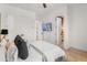 Comfortable bedroom features a tv, hardwood floors, open door to a bathroom, and neutral tones at 1506 E Tuckey Ln, Phoenix, AZ 85014