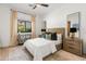Bright bedroom with a ceiling fan, natural light, a comfortable bed, and stylish decor at 1506 E Tuckey Ln, Phoenix, AZ 85014