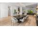Open dining room with wood floors, designer lighting, and view into the open concept living areas at 1506 E Tuckey Ln, Phoenix, AZ 85014