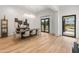 Bright dining room features wood floors, designer lighting, and backyard view through glass patio doors at 1506 E Tuckey Ln, Phoenix, AZ 85014