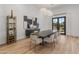 Open dining room featuring wood floors, designer chandelier, and modern decor and furnishings at 1506 E Tuckey Ln, Phoenix, AZ 85014
