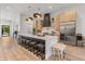 A modern kitchen features light wood cabinetry, a large island with seating and white marble countertops at 1506 E Tuckey Ln, Phoenix, AZ 85014