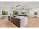 Open floor plan view of Kitchen and Living Room with an oversized island and a fireplace at 1506 E Tuckey Ln, Phoenix, AZ 85014