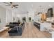 An open-concept living space featuring a spacious layout, modern decor, hardwood floors and seamless flow to the kitchen at 1506 E Tuckey Ln, Phoenix, AZ 85014