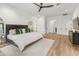 Bright main bedroom offers ample natural light and a serene atmosphere with wood floors, a ceiling fan and modern decor at 1506 E Tuckey Ln, Phoenix, AZ 85014