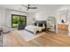 Serene main bedroom features wood floors, a neutral palette, and large windows offering views of the lush landscape at 1506 E Tuckey Ln, Phoenix, AZ 85014