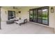Modern outdoor patio with comfortable seating, ceiling fan, and sliding glass doors at 1506 E Tuckey Ln, Phoenix, AZ 85014