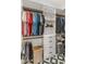 Spacious walk-in closet featuring custom shelving and hanging rods for optimal organization, with stylish flooring at 1506 E Tuckey Ln, Phoenix, AZ 85014