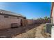 Spacious backyard featuring a block fence, stone pathway, and ample room for outdoor activities at 16150 N 86Th Ave, Peoria, AZ 85382