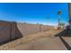 This backyard features a block fence, firepit, brick-paved patio, and ample room for outdoor activities at 16150 N 86Th Ave, Peoria, AZ 85382