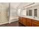 Primary bathroom with dual sinks, walk-in shower, and soaking tub under a window at 16150 N 86Th Ave, Peoria, AZ 85382