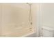 Bathroom with a shower-tub combo, tile walls, and toilet at 16150 N 86Th Ave, Peoria, AZ 85382