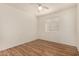 Bedroom with wood floors, a ceiling fan, and a large window at 16150 N 86Th Ave, Peoria, AZ 85382