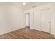 Bedroom with wood floors and a closet with sliding doors at 16150 N 86Th Ave, Peoria, AZ 85382