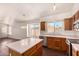 Open kitchen with stainless steel appliances, an island, dark wood floors, and lots of natural light at 16150 N 86Th Ave, Peoria, AZ 85382