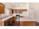 Functional kitchen with stainless steel appliances, wood cabinets, and light countertops at 16150 N 86Th Ave, Peoria, AZ 85382