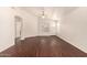 Living room showcasing dark wood floors, high ceilings, and a white door at 16150 N 86Th Ave, Peoria, AZ 85382