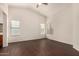 Spacious living room featuring dark wood floors, high ceilings, and large windows at 16150 N 86Th Ave, Peoria, AZ 85382