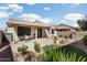 The private, covered patio overlooks lush desert landscaping, an artificial grass area, and ample seating at 16160 W Starlight Dr, Surprise, AZ 85374