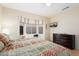 Inviting bedroom featuring a bay window, dresser, ceiling fan, and natural light at 16160 W Starlight Dr, Surprise, AZ 85374