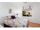 Well-lit bedroom featuring ceiling fan, a plush bed, wood-look floors, and a window view at 16160 W Starlight Dr, Surprise, AZ 85374