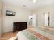 Comfortable bedroom displaying wood-look floors, ceiling fan, a dresser, and access to kitchen and bath at 16160 W Starlight Dr, Surprise, AZ 85374