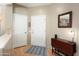 Inviting entryway boasts neutral walls, wood flooring, a hall closet, and a drop-leaf table at 16160 W Starlight Dr, Surprise, AZ 85374