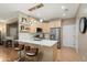 Modern kitchen with light wood cabinetry, quartz countertops, a breakfast bar, and stainless steel appliances at 16160 W Starlight Dr, Surprise, AZ 85374